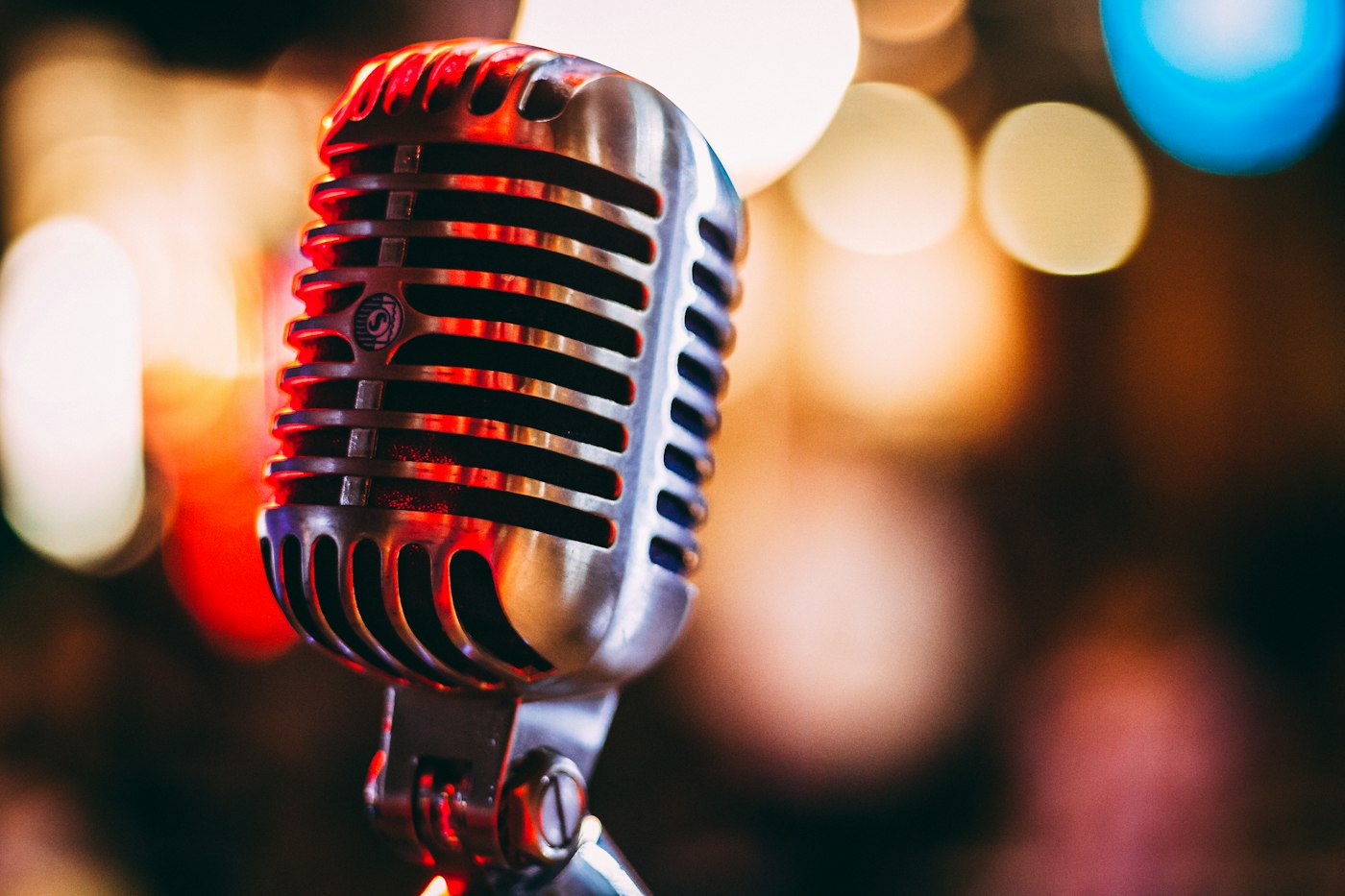 A microphone on a stage under warm spotlights before a show