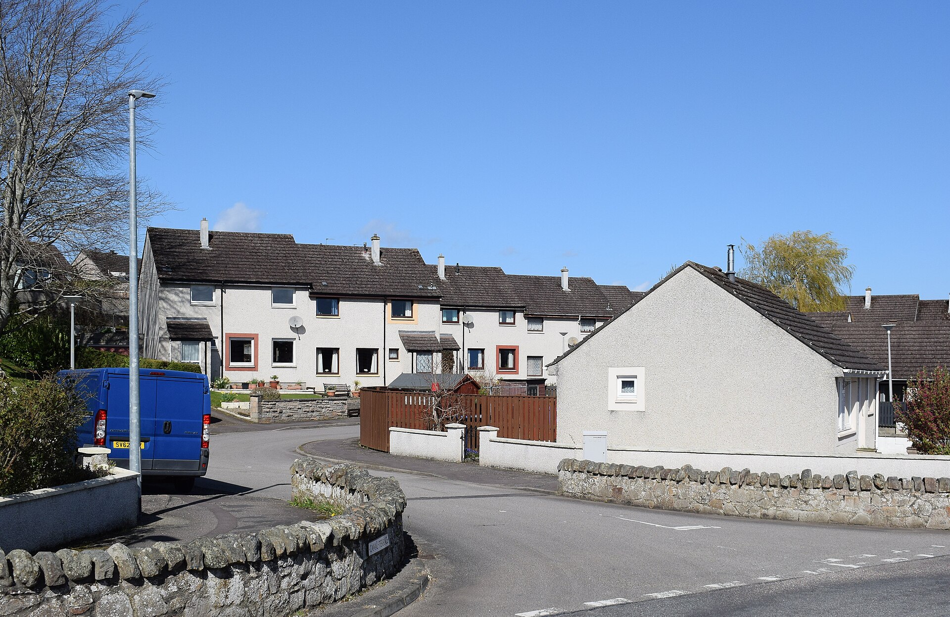 A bright suburban street of single-family homes in daylight (file photo)