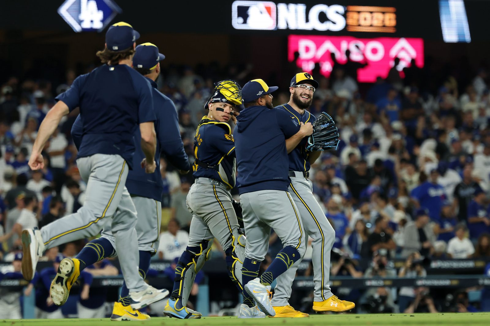 Milwaukee Brewers players celebrate on the field after clinching the National League pennant