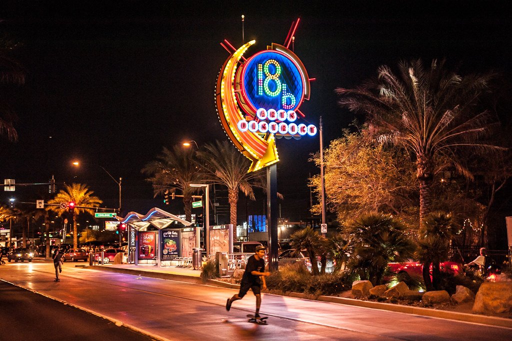 The neon 18b Arts District sign glowing at night on Charleston Boulevard
