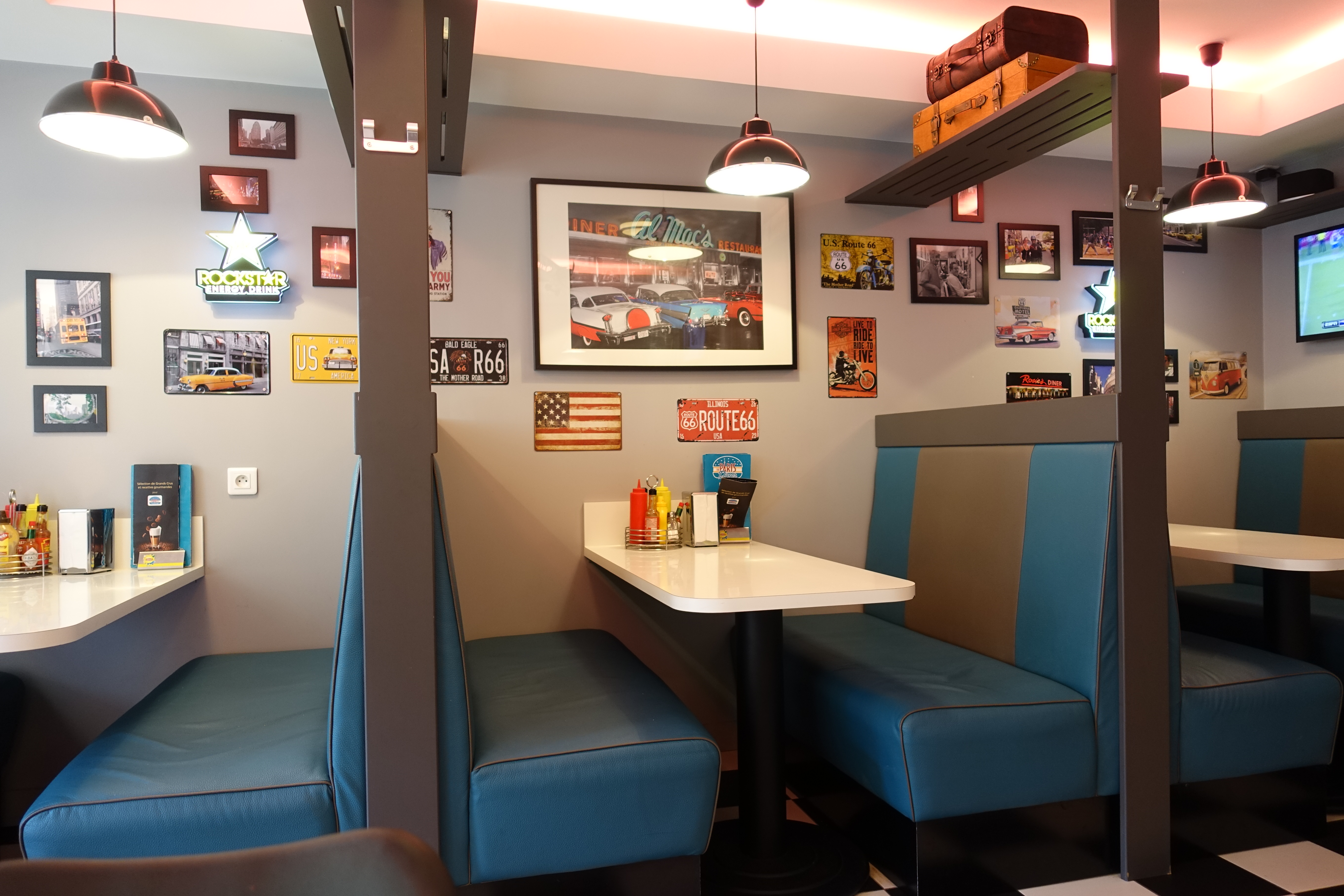 The interior of The Paris Diner with turquoise booths, Route 66 signs and American memorabilia