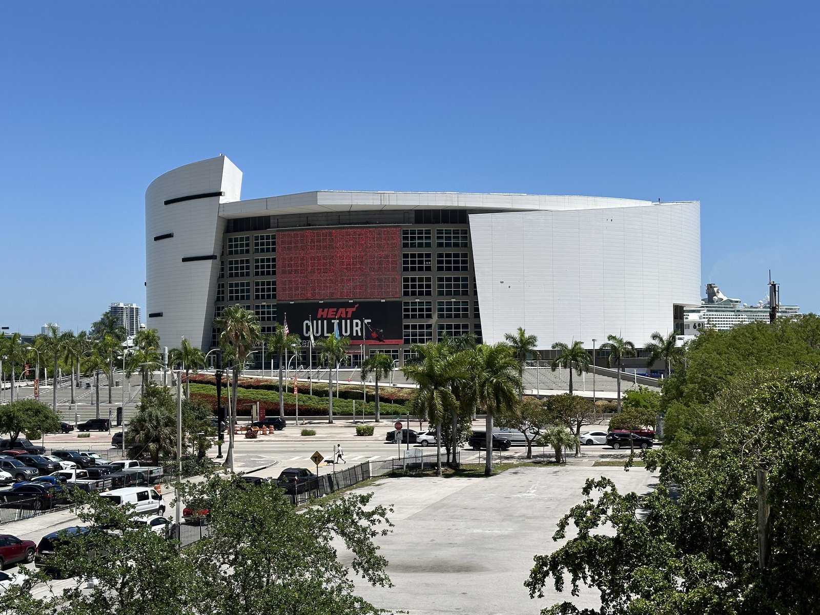 Kaseya Center, home of the Miami Heat, under a bright blue Miami sky with the red HEAT CULTURE banner on the facade