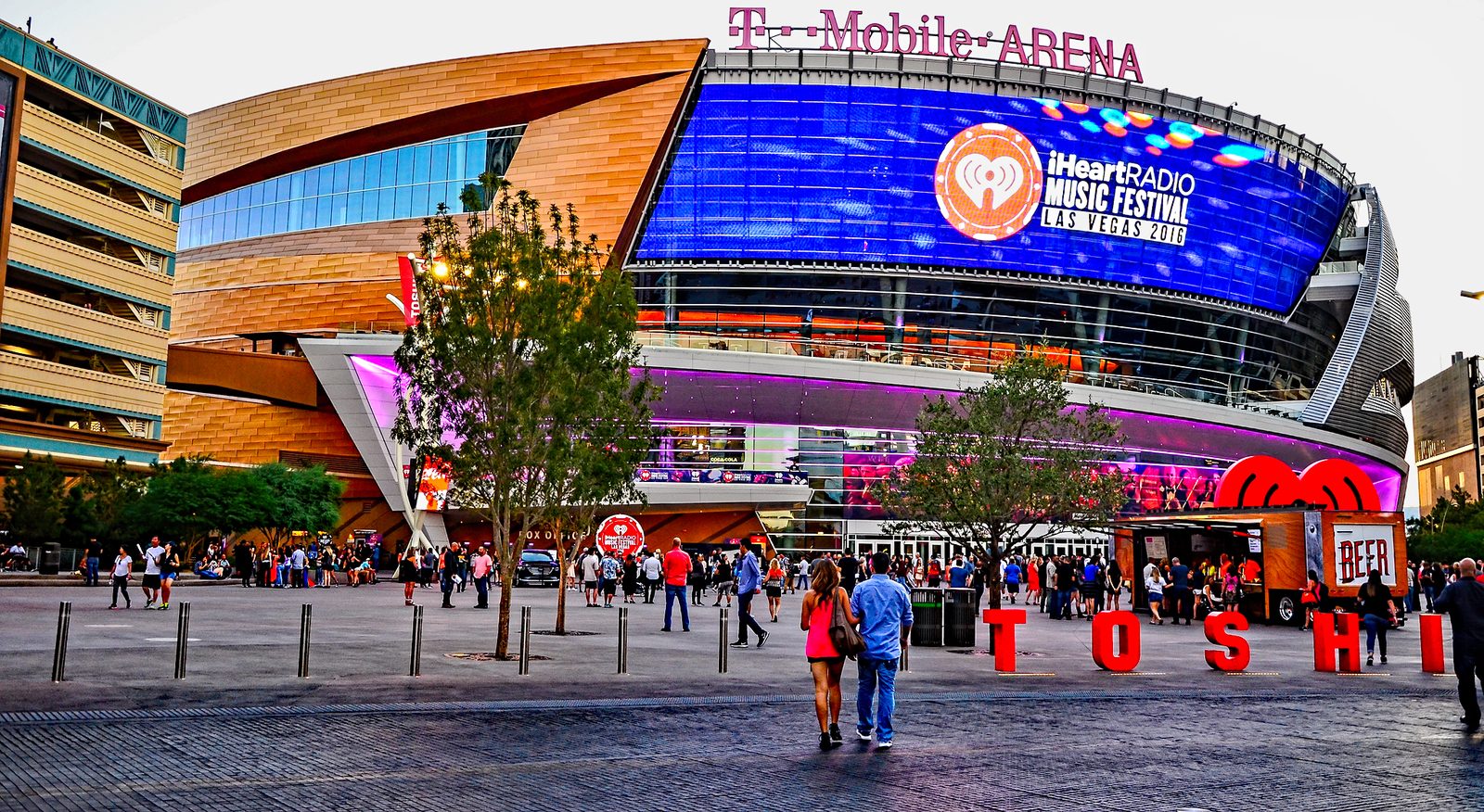 T-Mobile Arena on a bright afternoon with fans gathering in Toshiba Plaza.