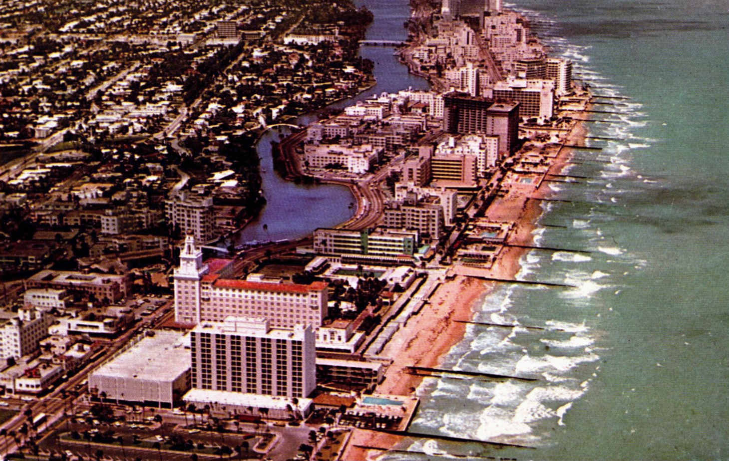 A vintage aerial postcard view of Miami Beach's beachfront hotels and turquoise shoreline