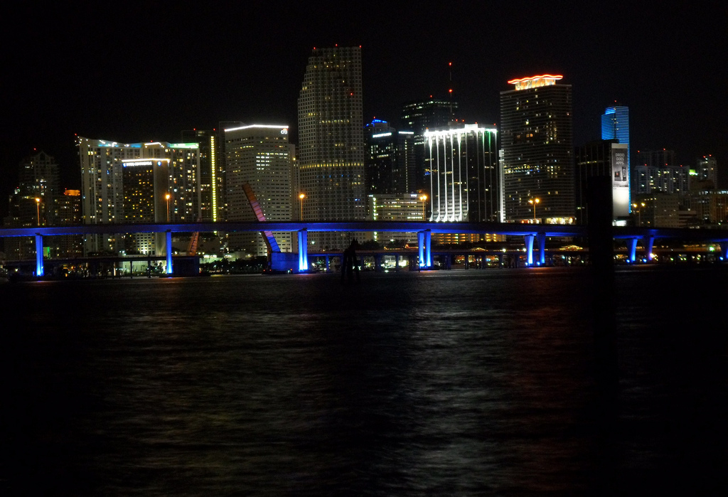 The downtown Miami skyline glowing over Biscayne Bay at night