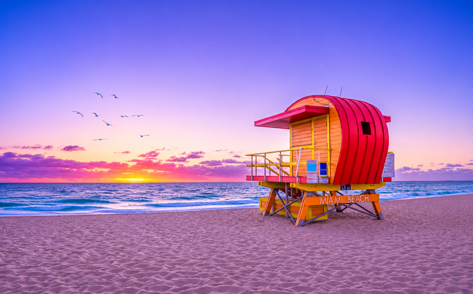 A colorful South Beach lifeguard tower under a bright Florida sky