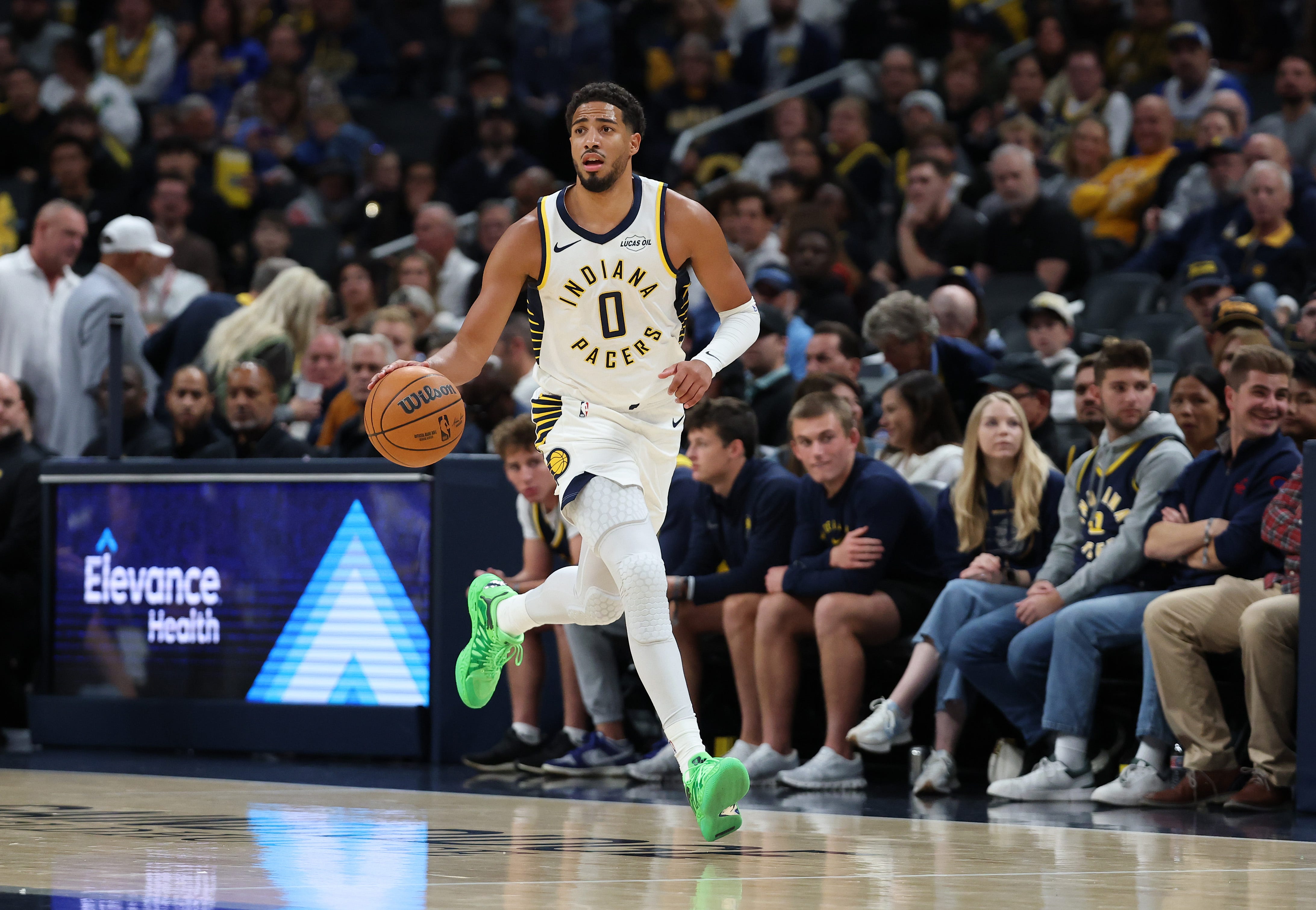 Tyrese Haliburton in Indiana's white home uniform (No. 0) bringing the ball up court at Gainbridge Fieldhouse during his October 2026 comeback, home crowd behind him