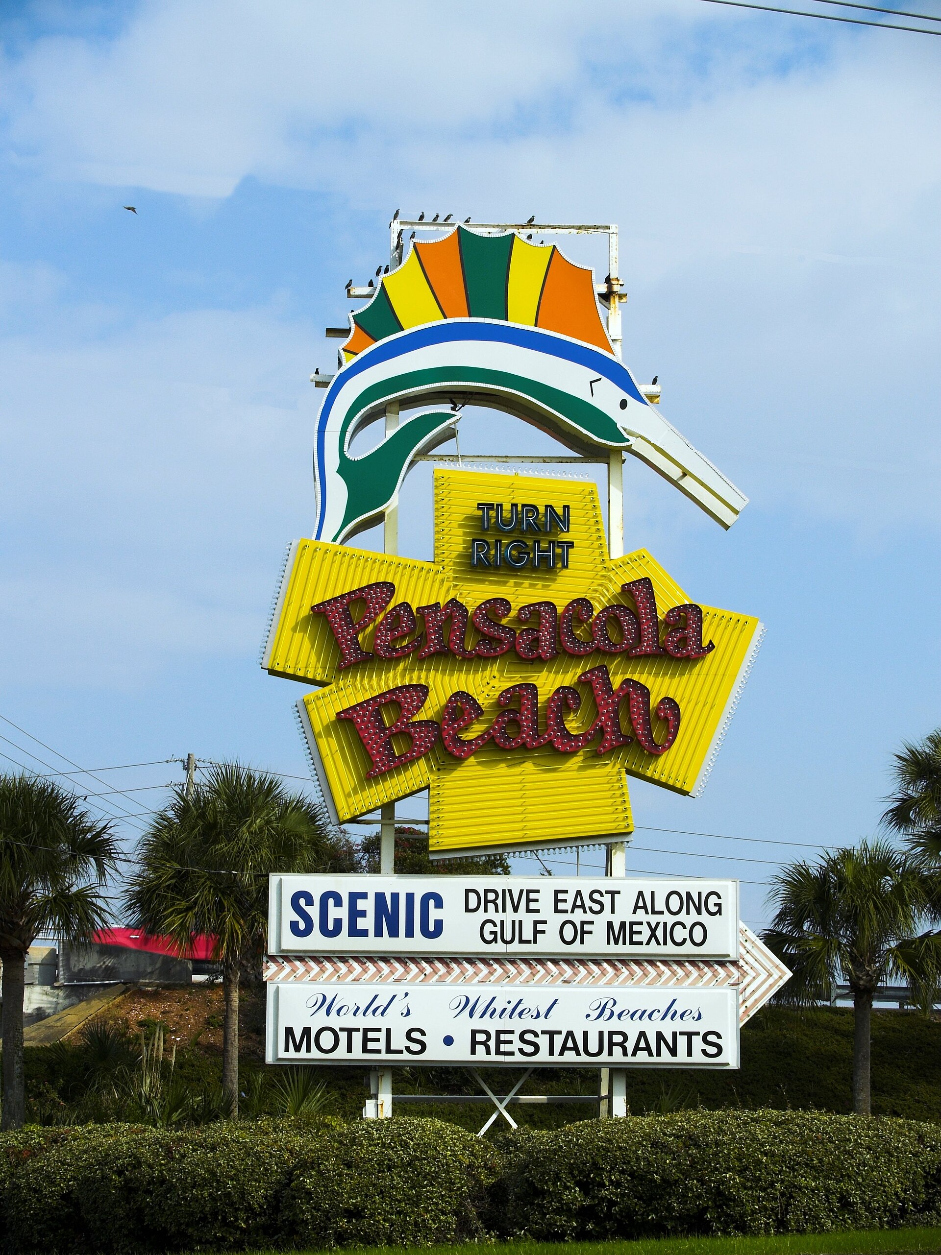 The Pensacola Beach sign under blue skies