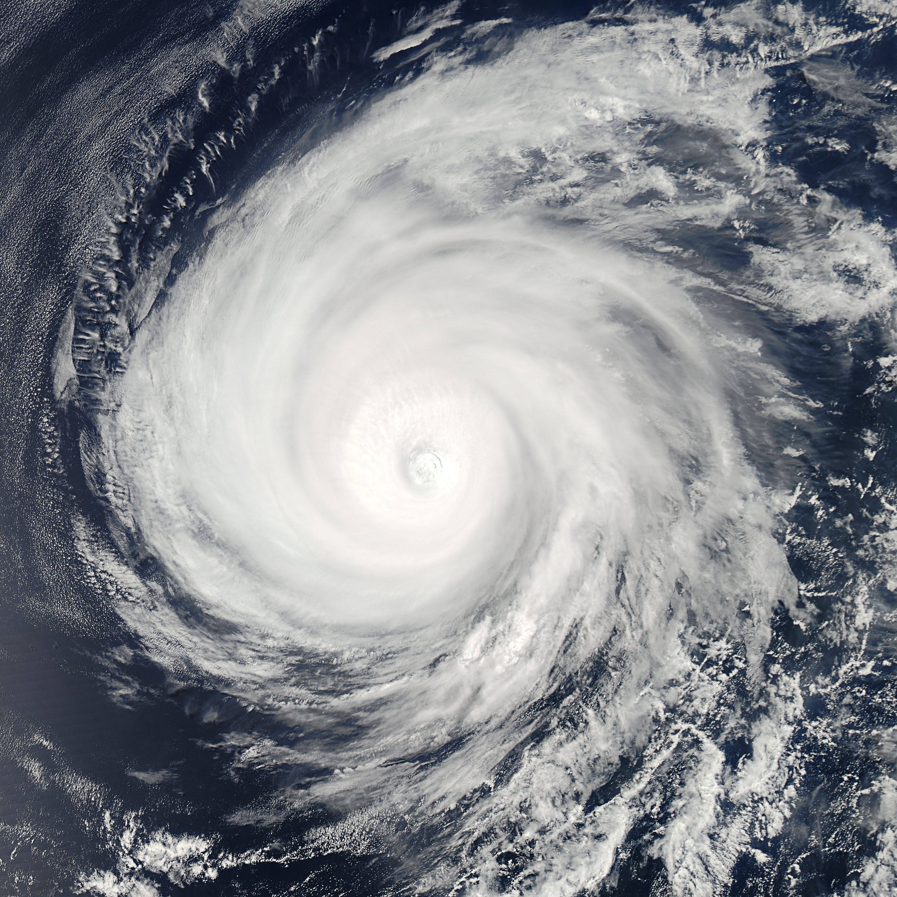 Satellite view of a powerful hurricane swirling off a coastline