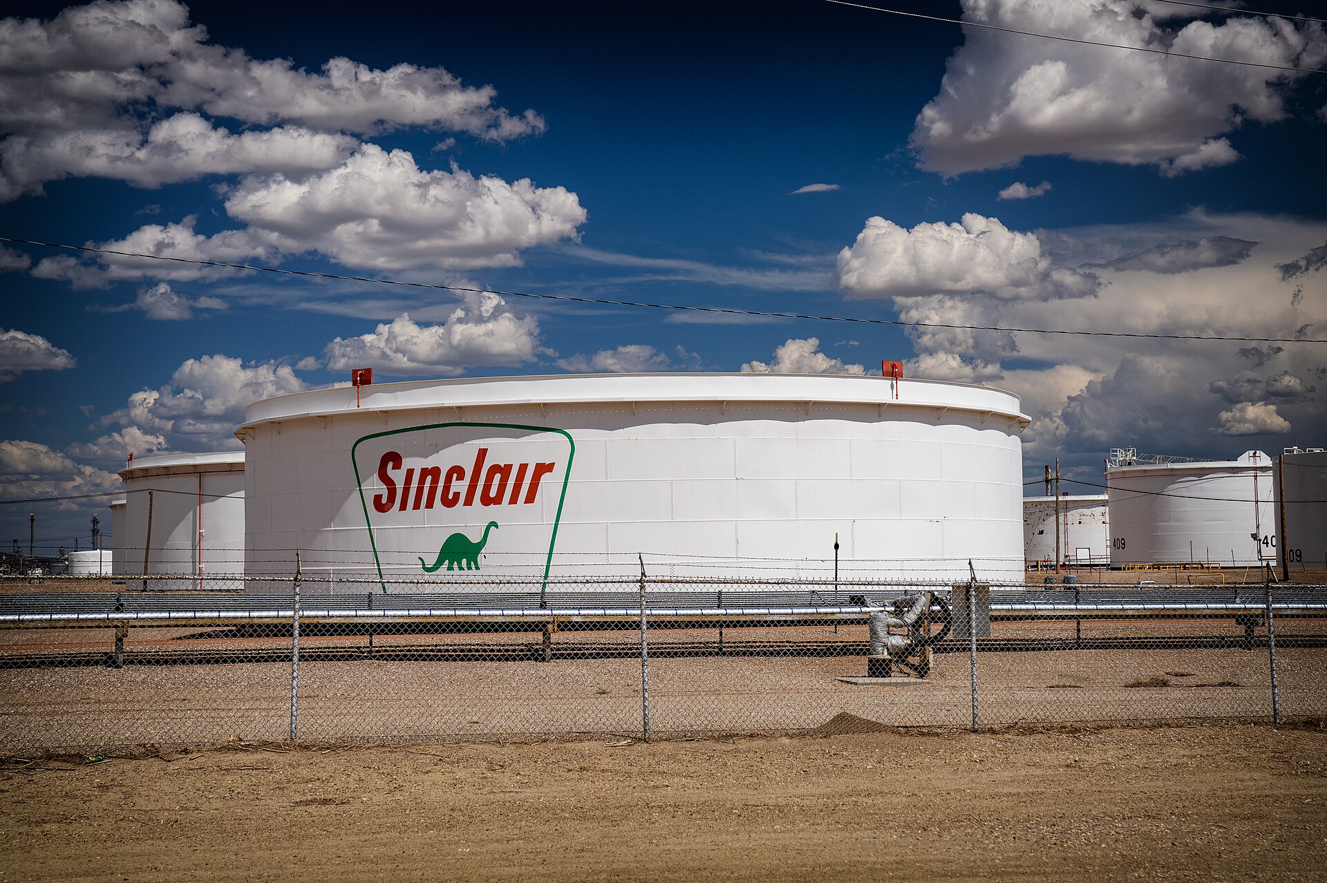 Fuel storage tanks at an energy depot under a bright sky