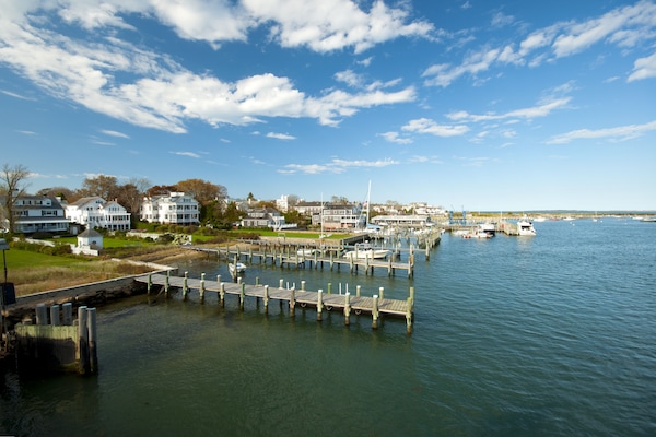 A bright marina and harbor on Martha's Vineyard, sailboats docked along wooden piers