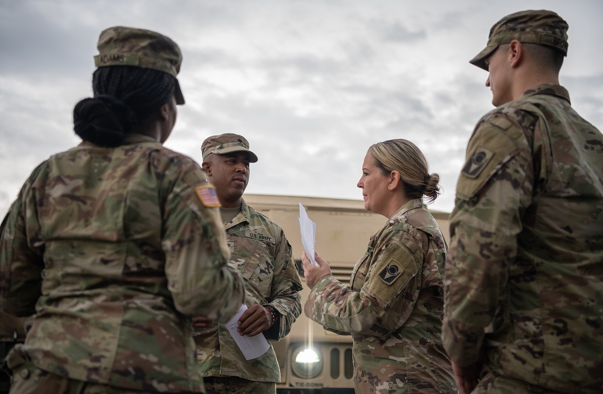 Florida National Guard soldiers during a hurricane response briefing; the governor's emergency order authorizes activating the Guard