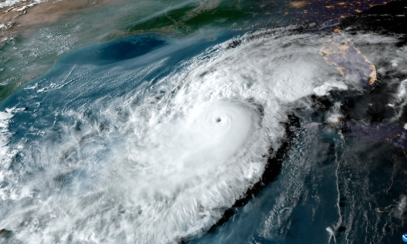 NOAA GOES-16 satellite imagery of a hurricane churning in the Gulf of Mexico, with the Florida peninsula visible at right