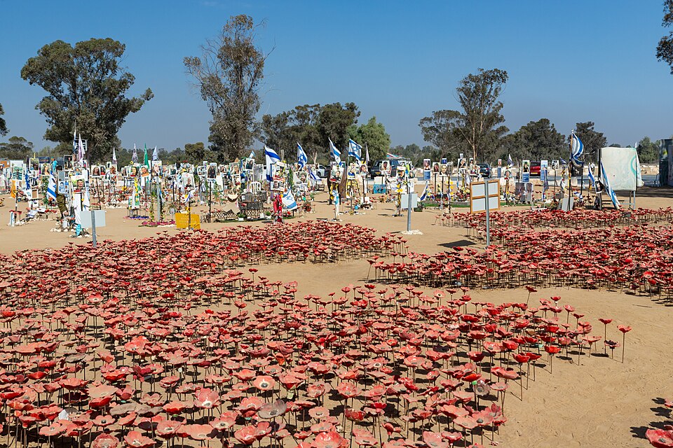 The Nova festival memorial site at Re’im on the October 7 anniversary, with rows of flowers and photographs of the victims