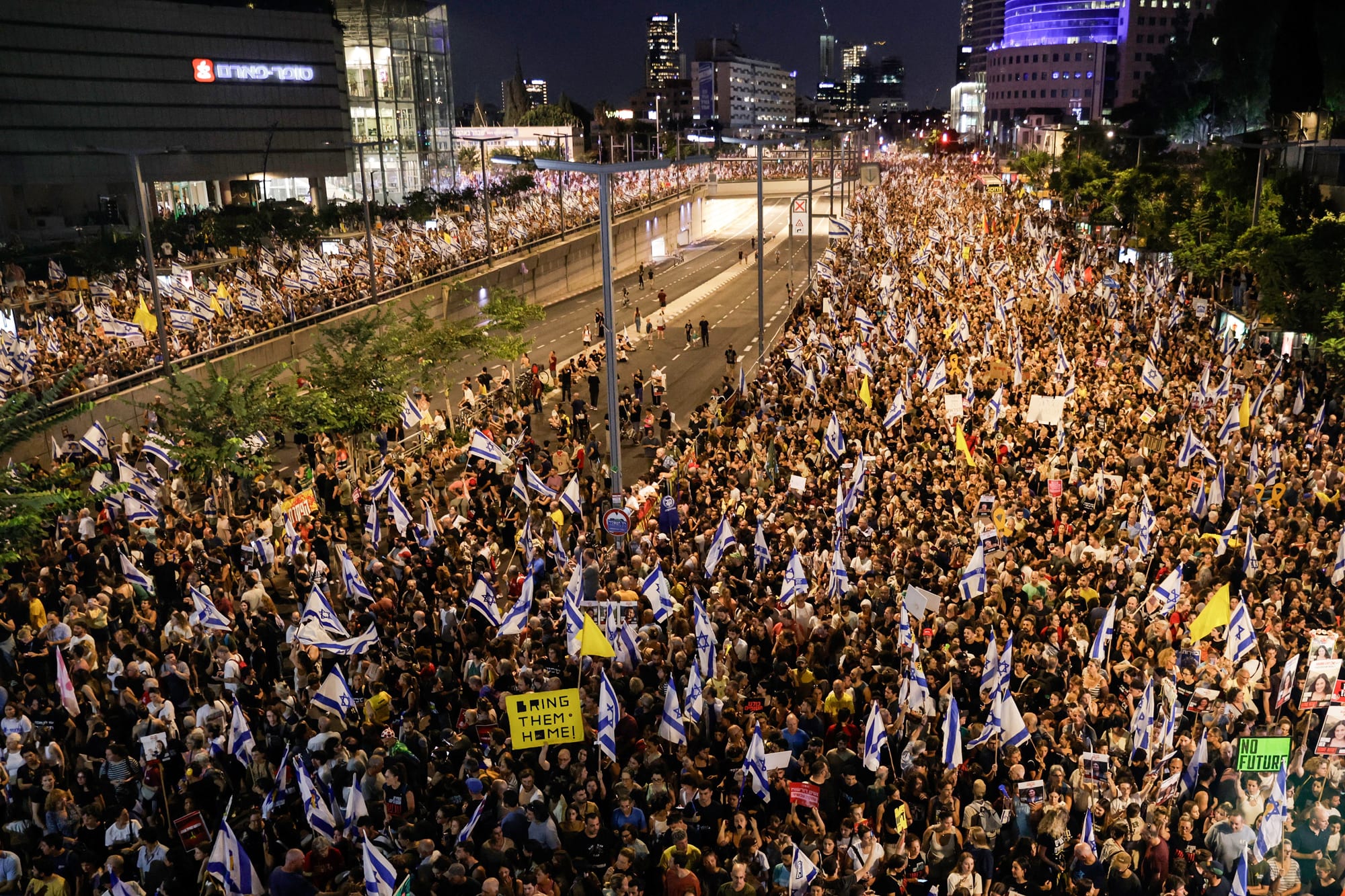 Massive nighttime rally in Tel Aviv with Israeli flags and ‘Bring Them Home’ signs