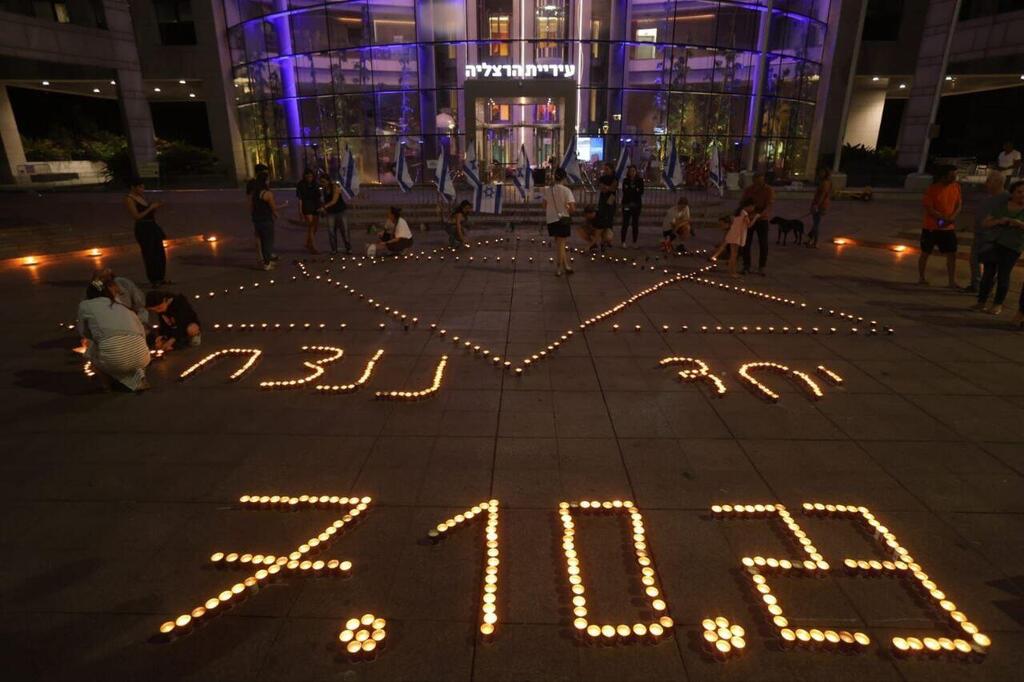 Candles spelling out the date 7.10.2023 at a memorial in Israel