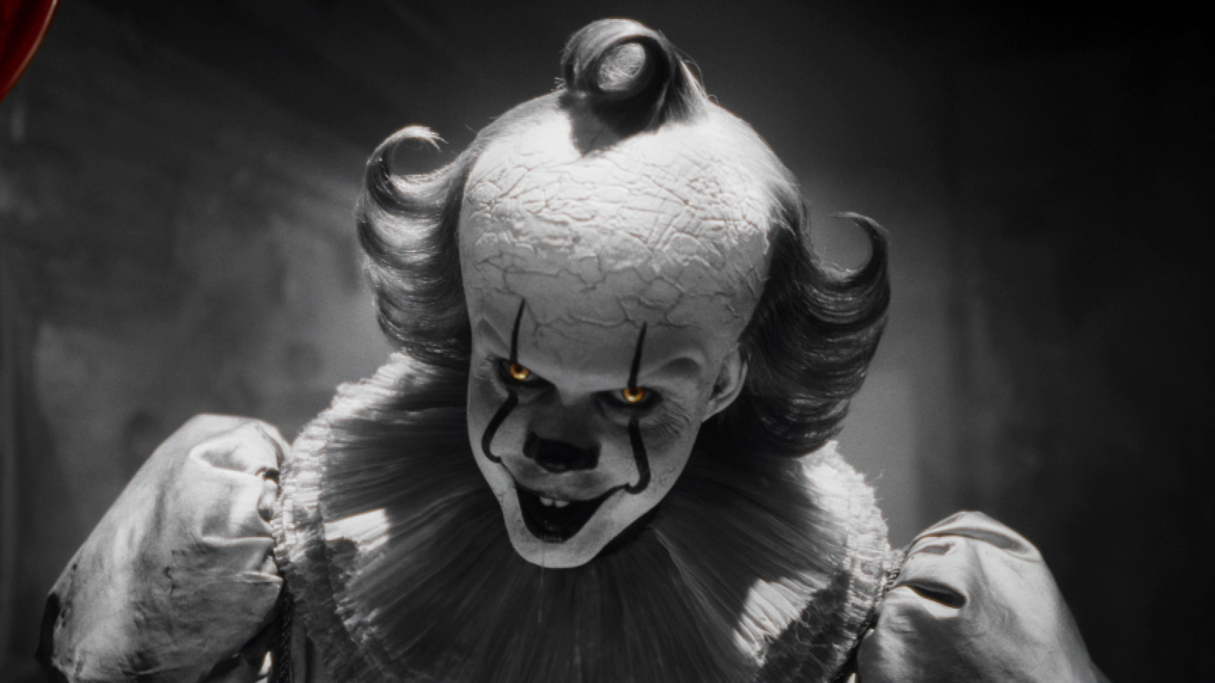 Bill Skarsgård as Pennywise in a black-and-white series still from It: Welcome to Derry