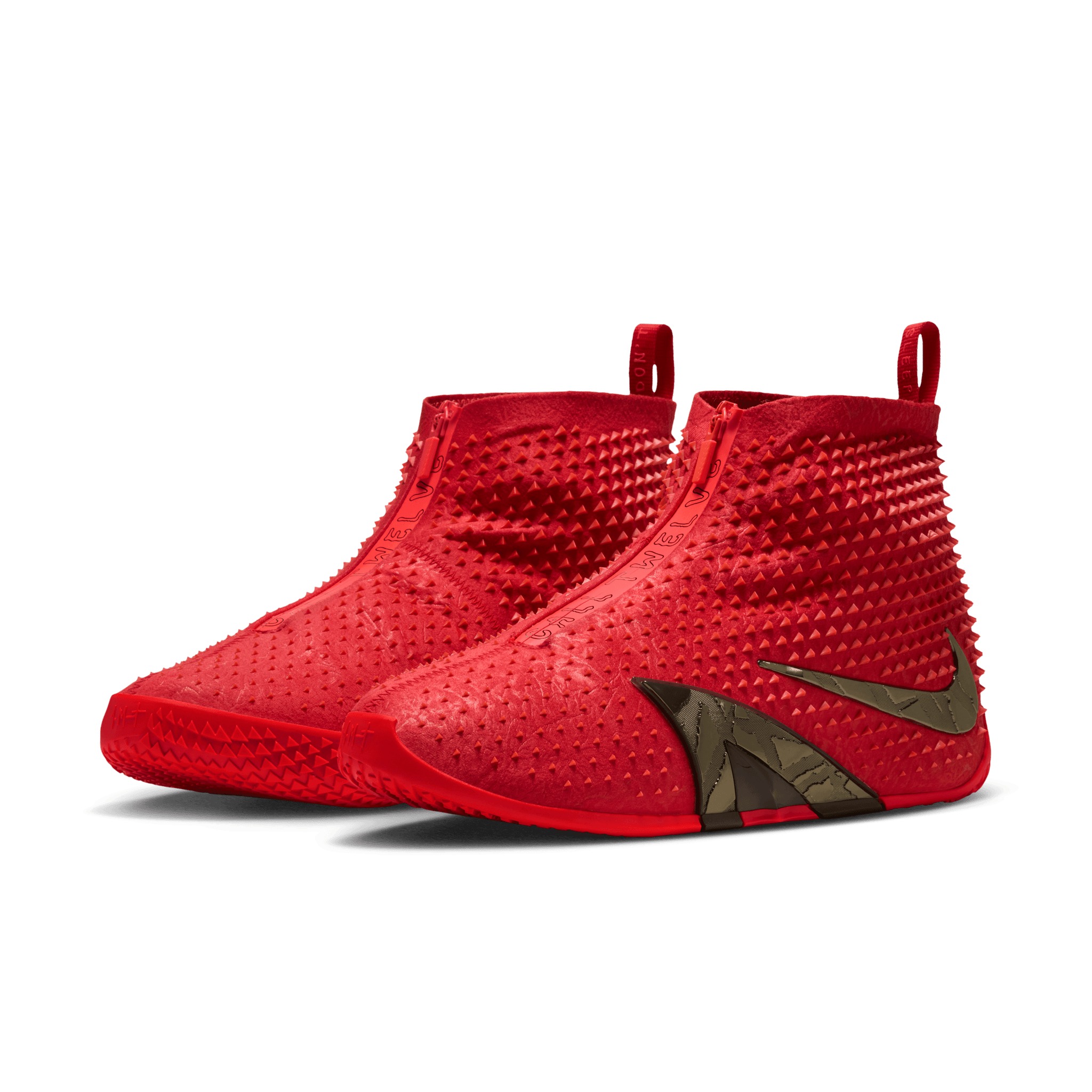 The Ja 4 High “Zombie” pair from the front three-quarter — zippered shrouds lettered CALL TWELVE, studded red uppers, metallic olive Swooshes.