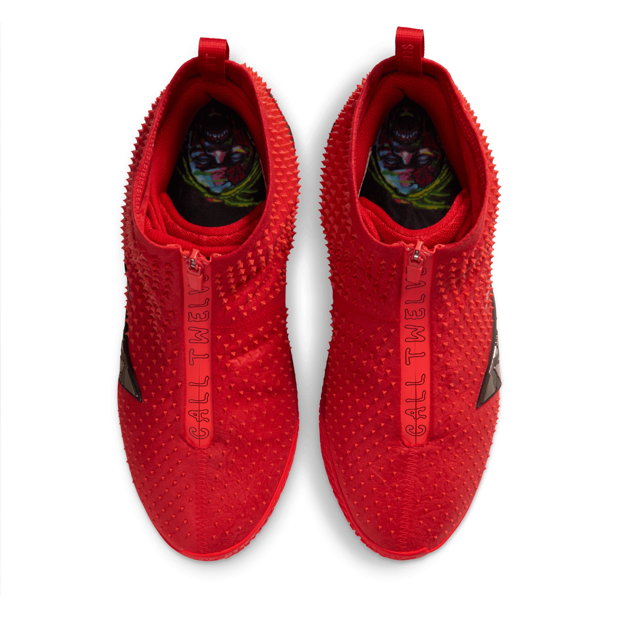 Top view of the Ja 4 High “Zombie” pair — CALL TWELVE printed down both zippers, with the zombie-Ja insole graphic visible inside each shoe.