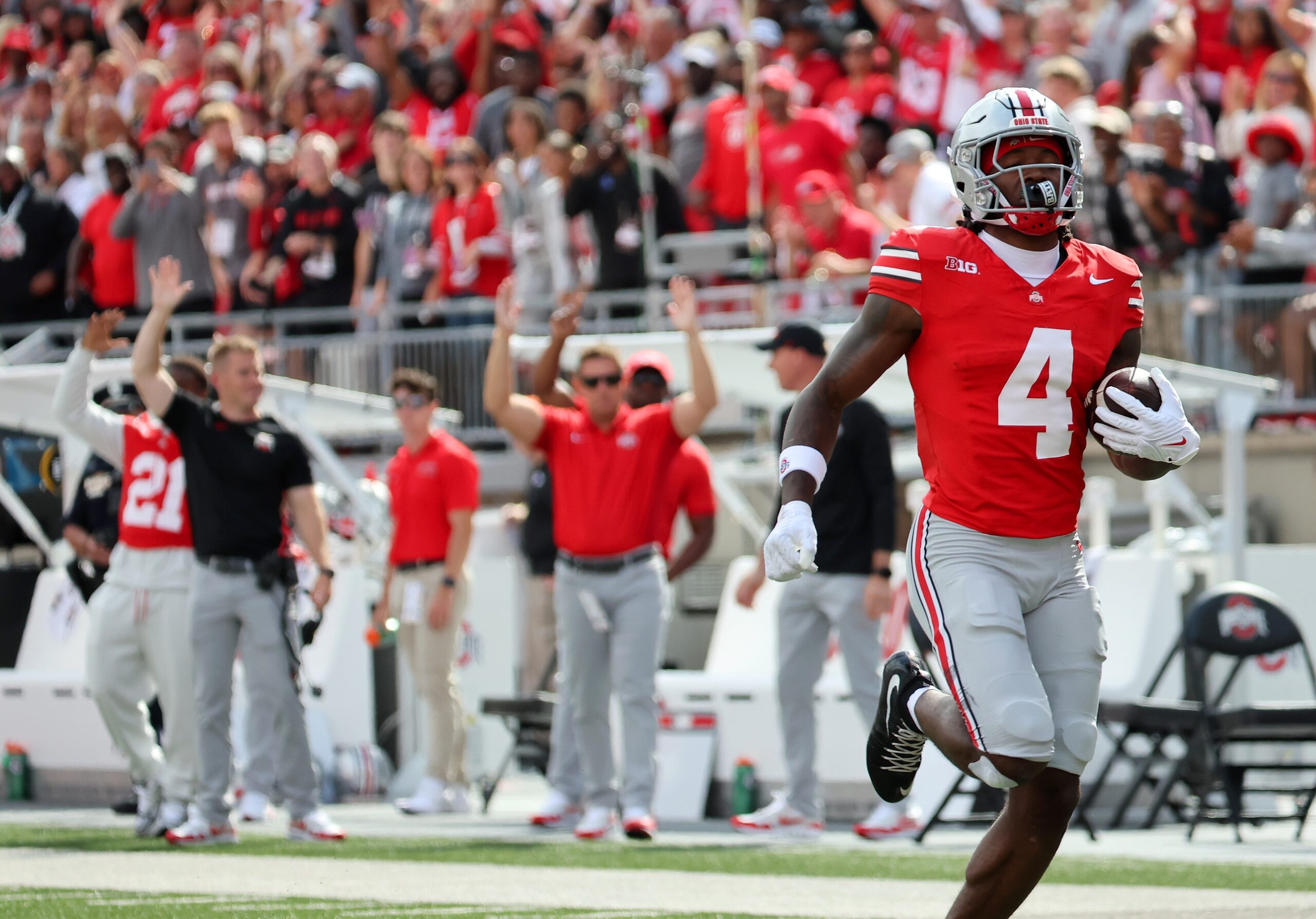 Ohio State wide receiver Jeremiah Smith runs with the ball during a game
