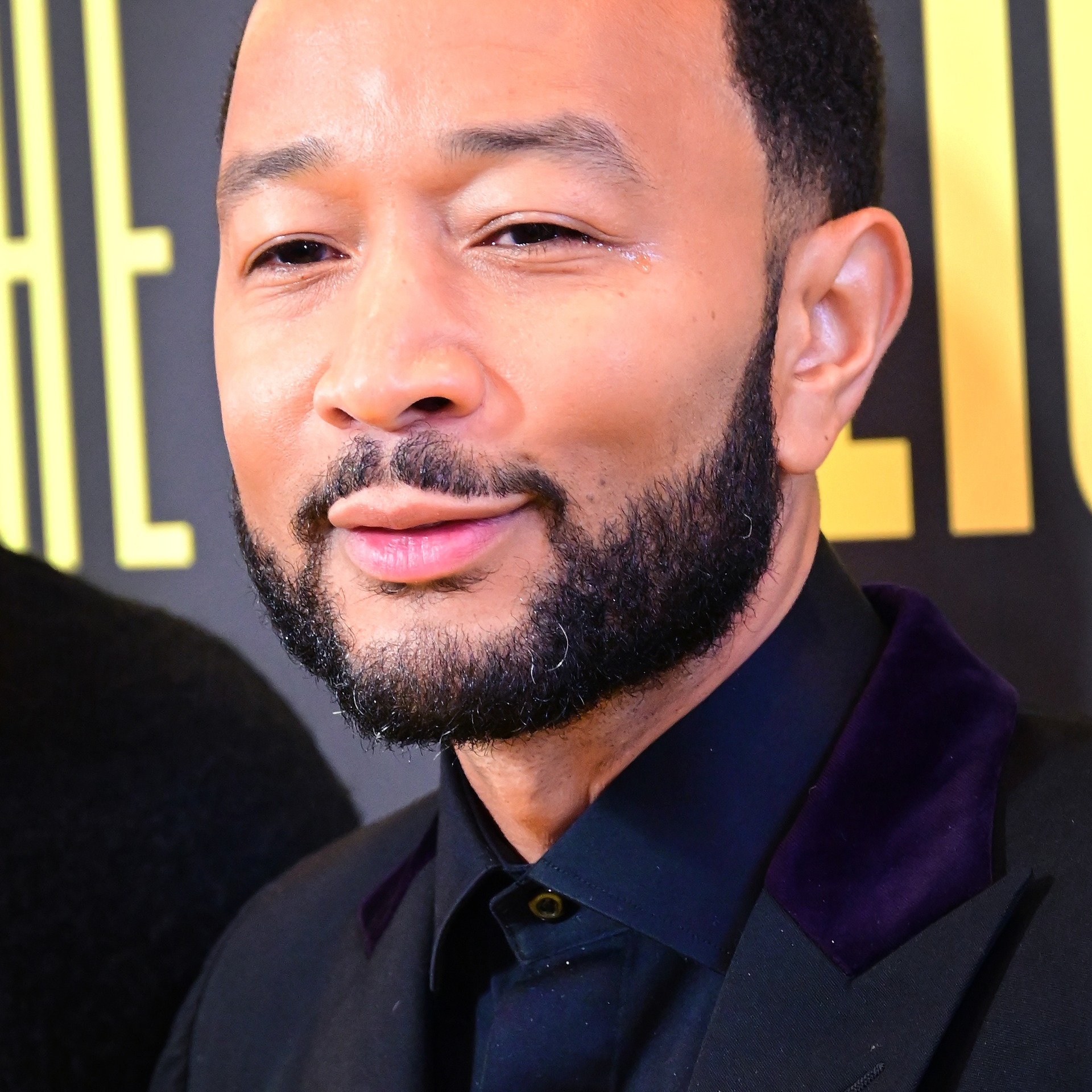 John Legend in a black suit with a purple velvet collar at the Broadway opening night of 'Cats: The Jellicle Ball' in New York, April 2026