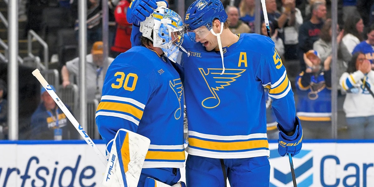 St. Louis Blues goaltender Joel Hofer (30) receives a tap on the mask from alternate captain Colton Parayko (55) after the Blues' 6-2 win over the Vegas Golden Knights at Enterprise Center in St. Louis on October 22, 2026