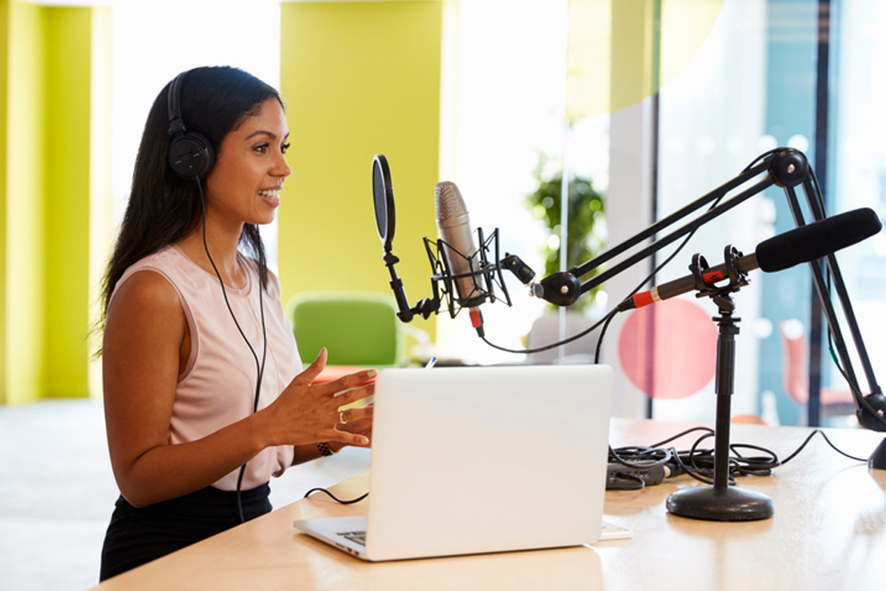 A podcaster recording in a studio with a professional microphone
