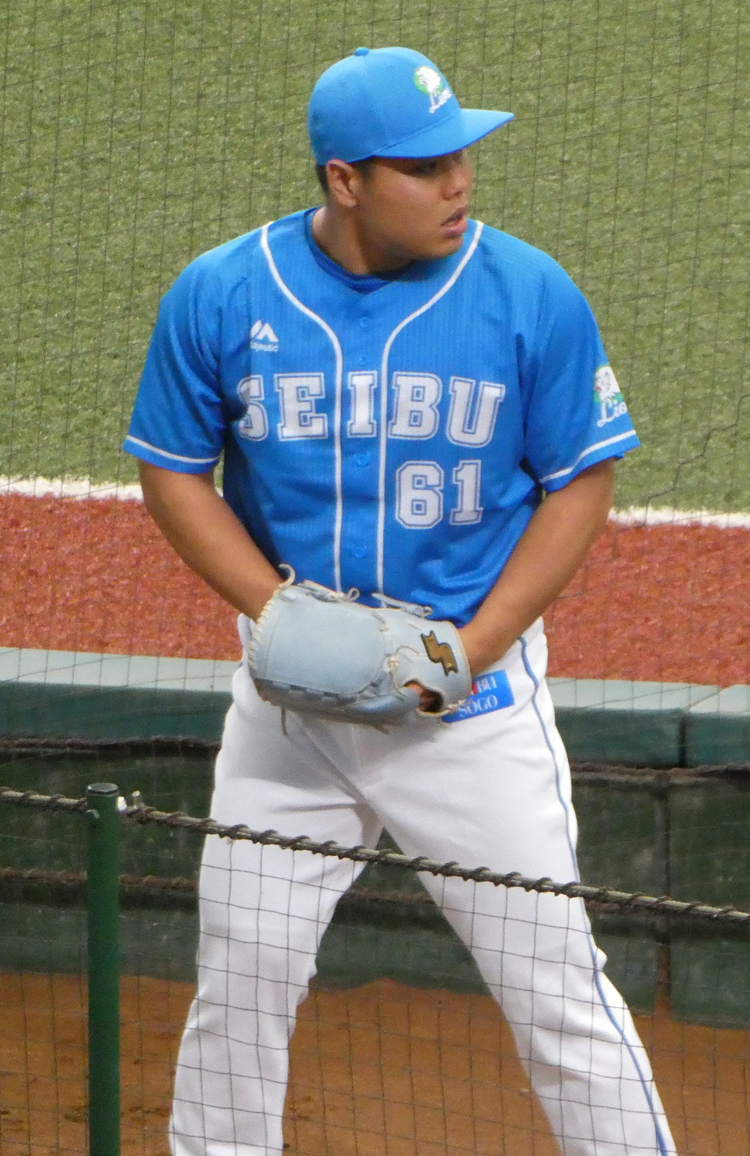 Kaima Taira front-on in the Saitama Seibu Lions' light-blue jersey, No. 61, glove in hand at Belluna Dome