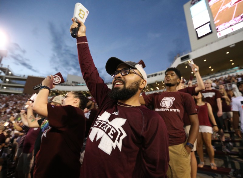 Mississippi State fans ringing cowbells in the stands on game day
