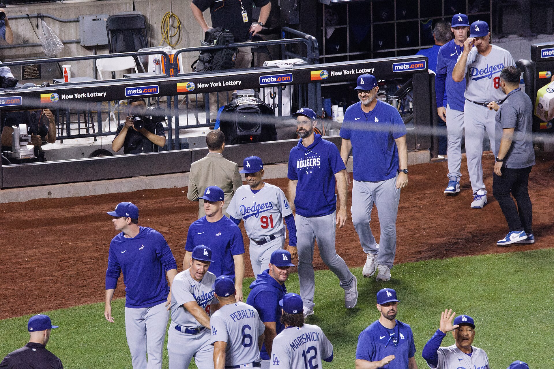 Dodgers players and coaches on the field after a win