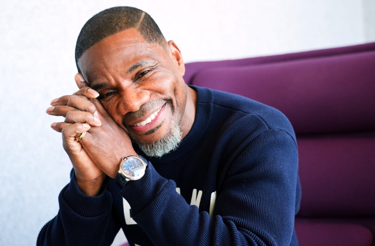 Kirk Franklin smiling, hands clasped, in an Associated Press portrait
