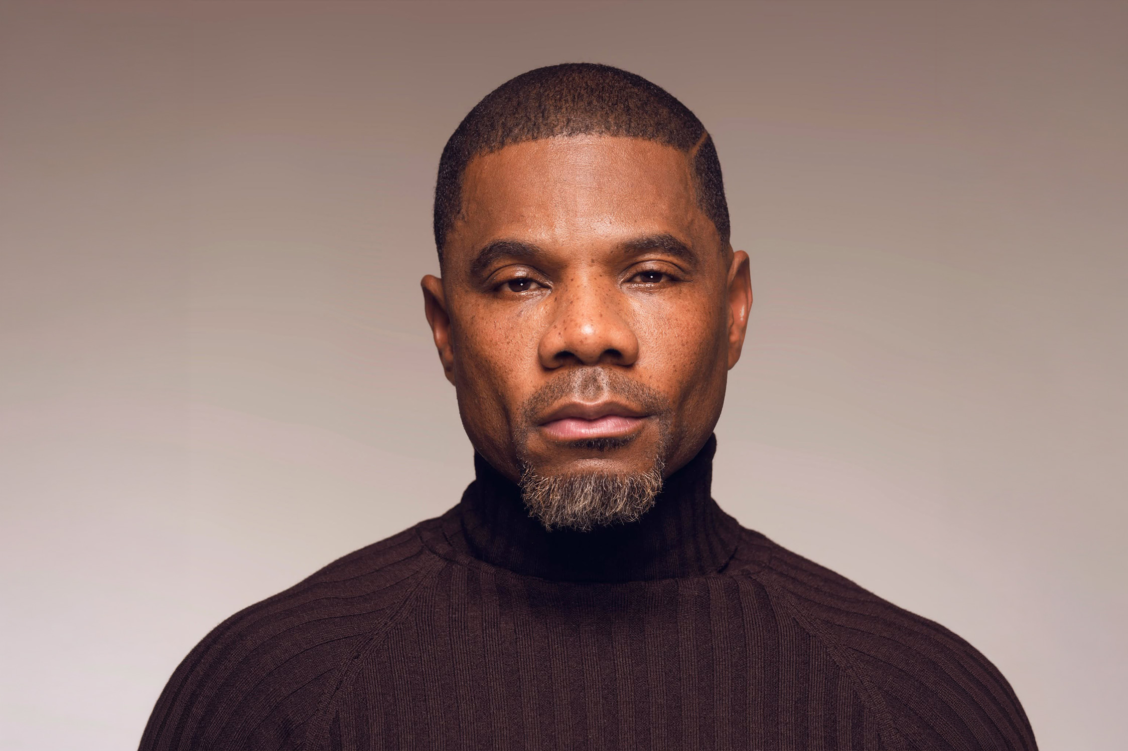Studio portrait of Kirk Franklin in a black turtleneck