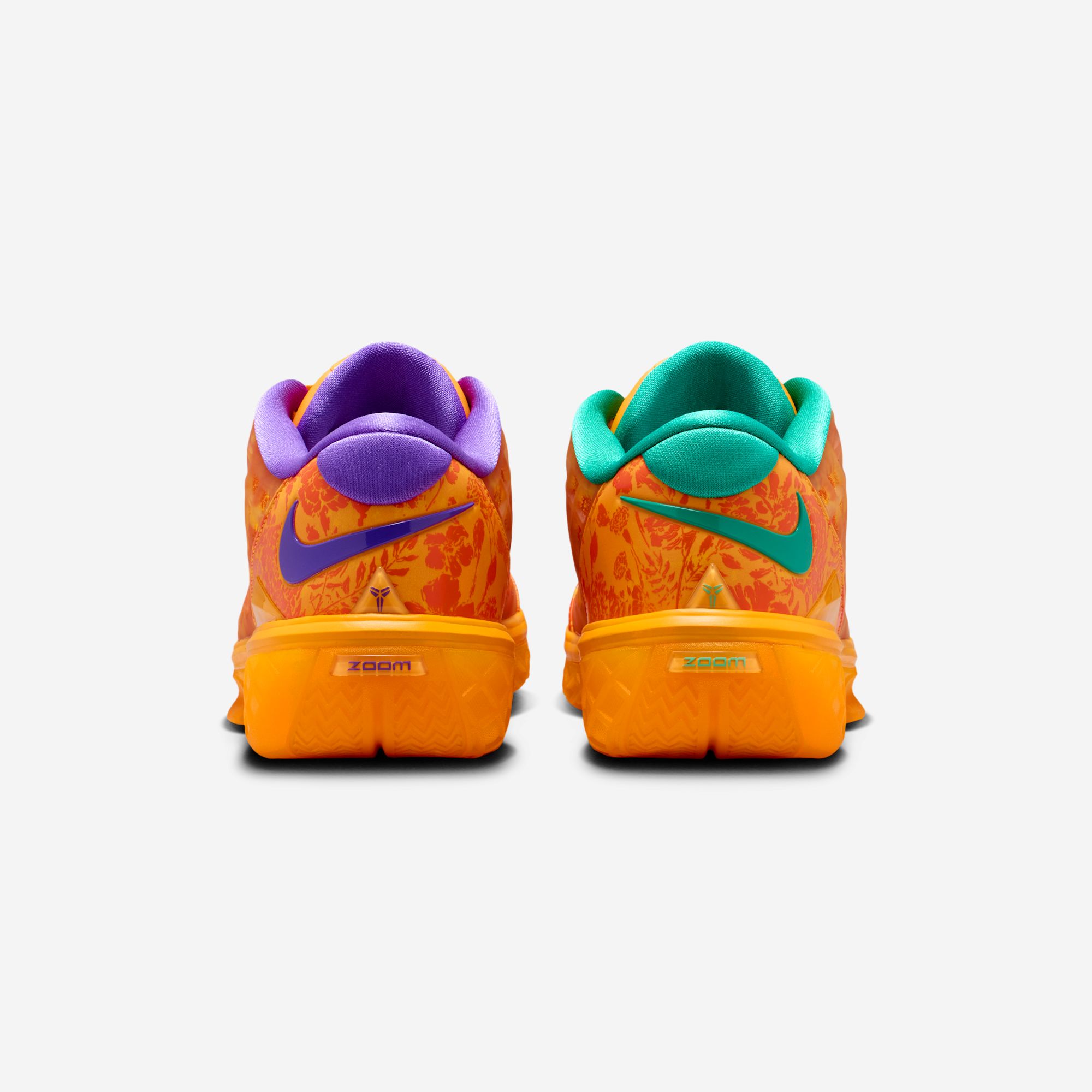The heels together — Hyper Grape Swoosh on one shoe, Emerald Green on the other, over floral heels with Zoom branding