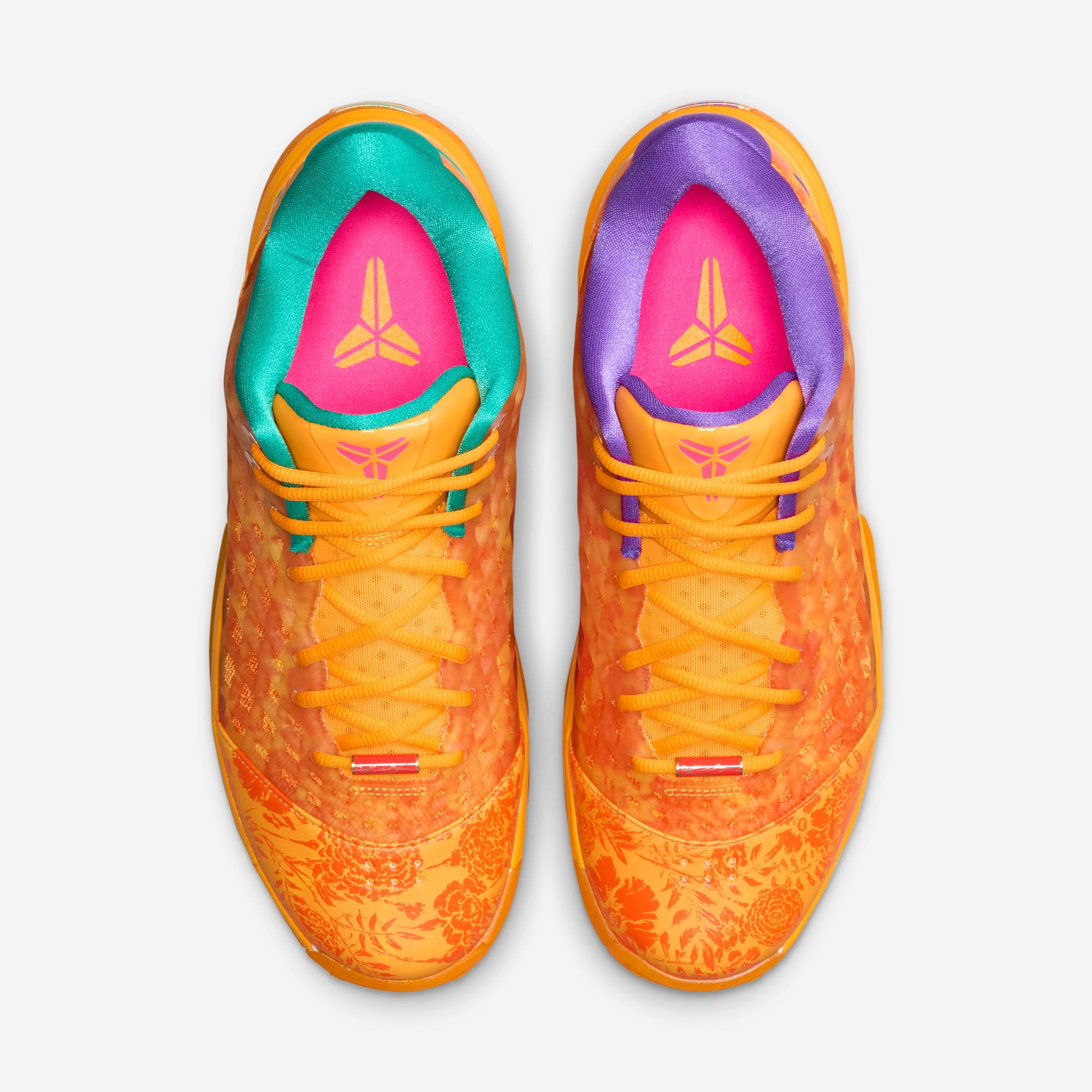 The pair from above — Emerald Green collar on one shoe, Hyper Grape on the other, pink tongues with gold Kobe sheath logos: the asymmetry story in one frame