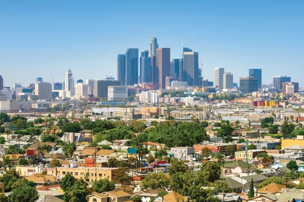Downtown Los Angeles skyline under a clear blue daytime sky