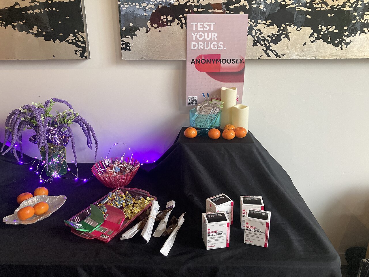 A harm reduction drug-checking table with testing supplies