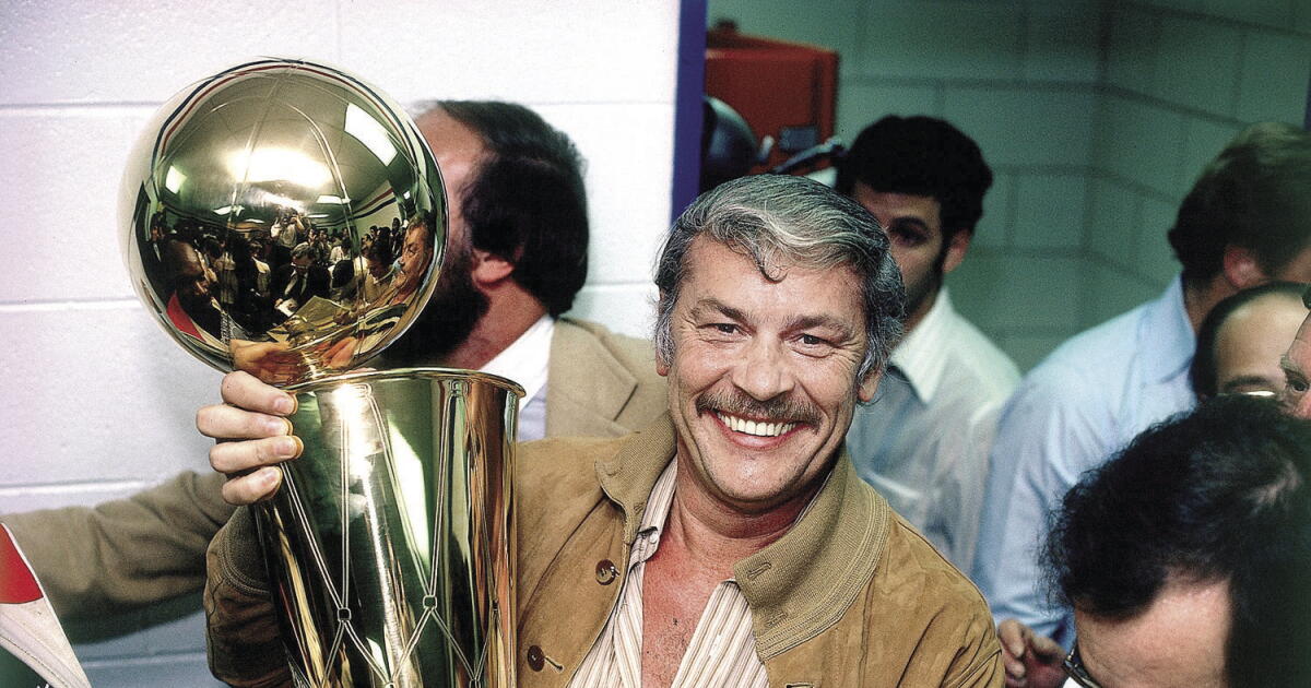 Dr. Jerry Buss holding the NBA championship trophy