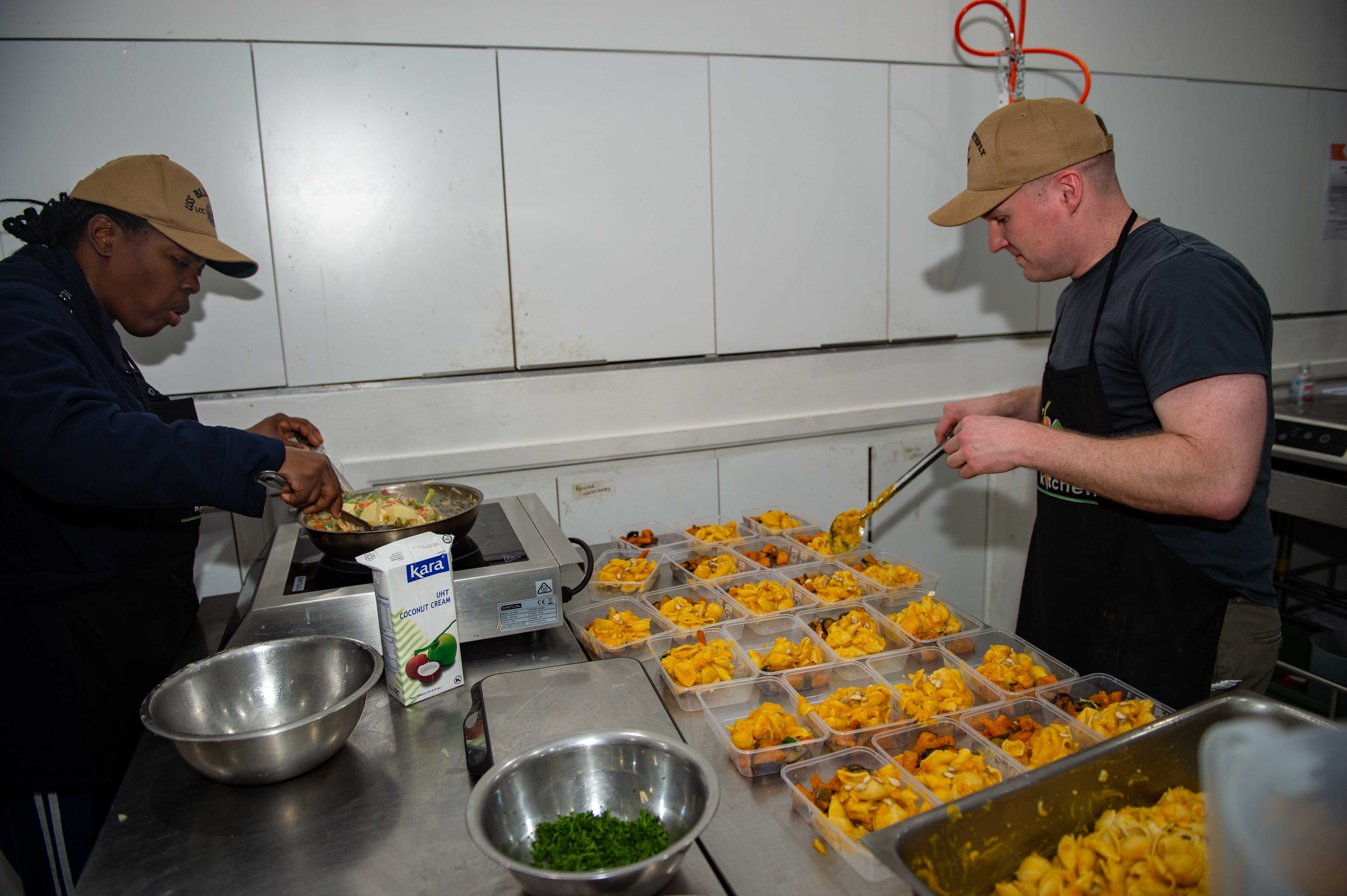 Volunteers preparing food in a community kitchen
