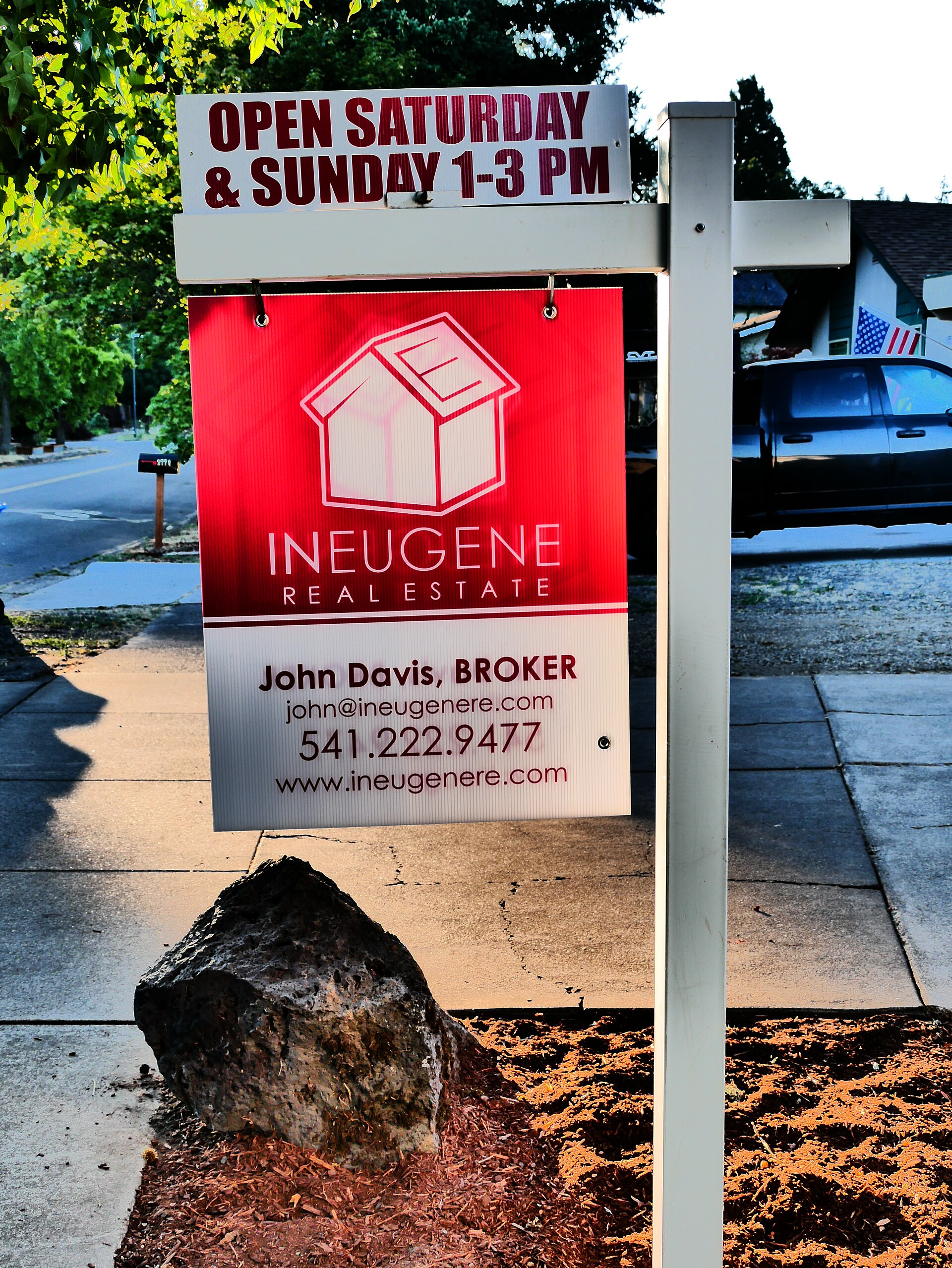 For sale and open house signs in front of a home
