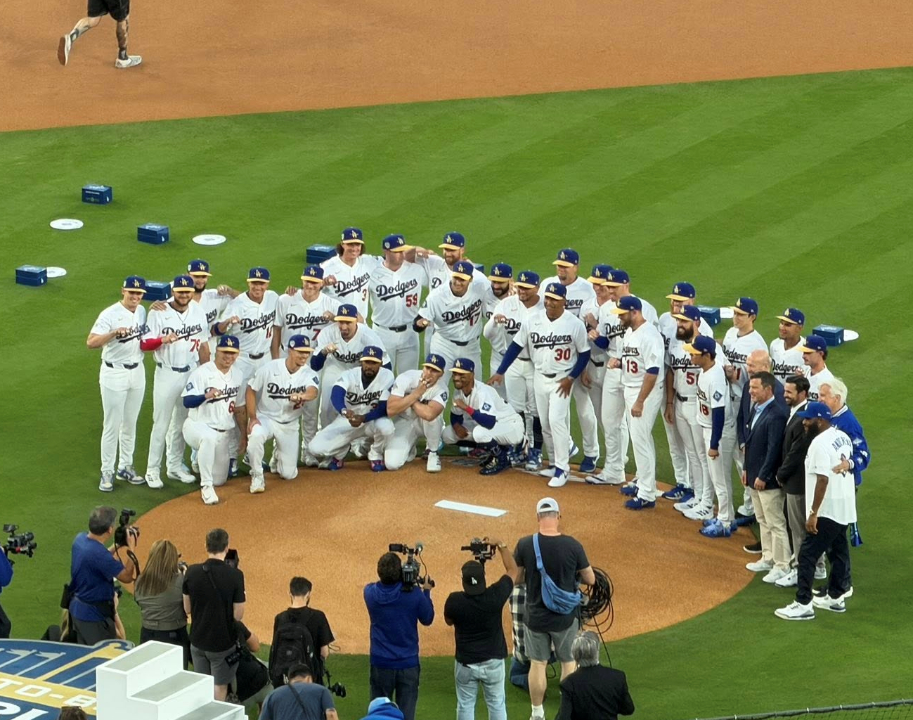 The Dodgers pose on the mound at Dodger Stadium during their 2026 championship ring ceremony