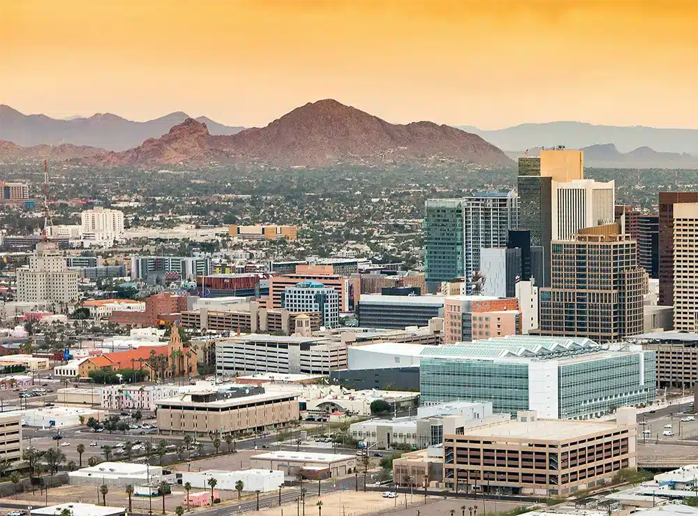 The Phoenix skyline in daylight with Camelback Mountain in the distance