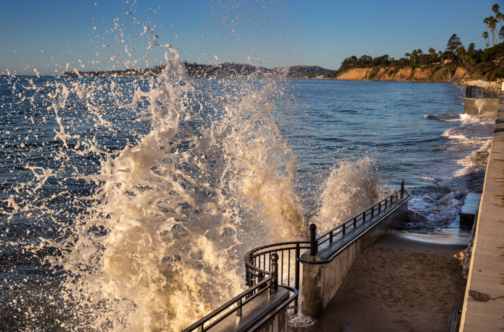 Ocean waves crashing against a seawall on the Southern California coast