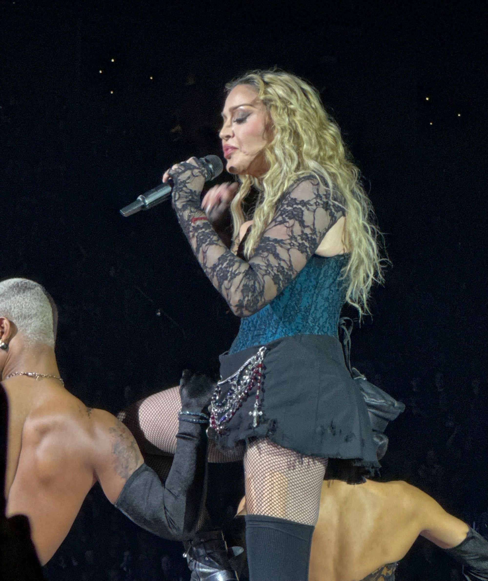 Madonna performing on stage in a brightly lit concert spectacle