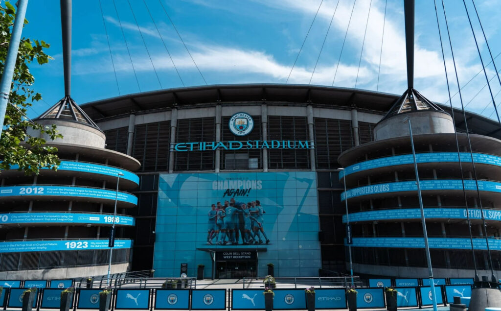 The Etihad Stadium, home of Manchester City, under a clear blue sky