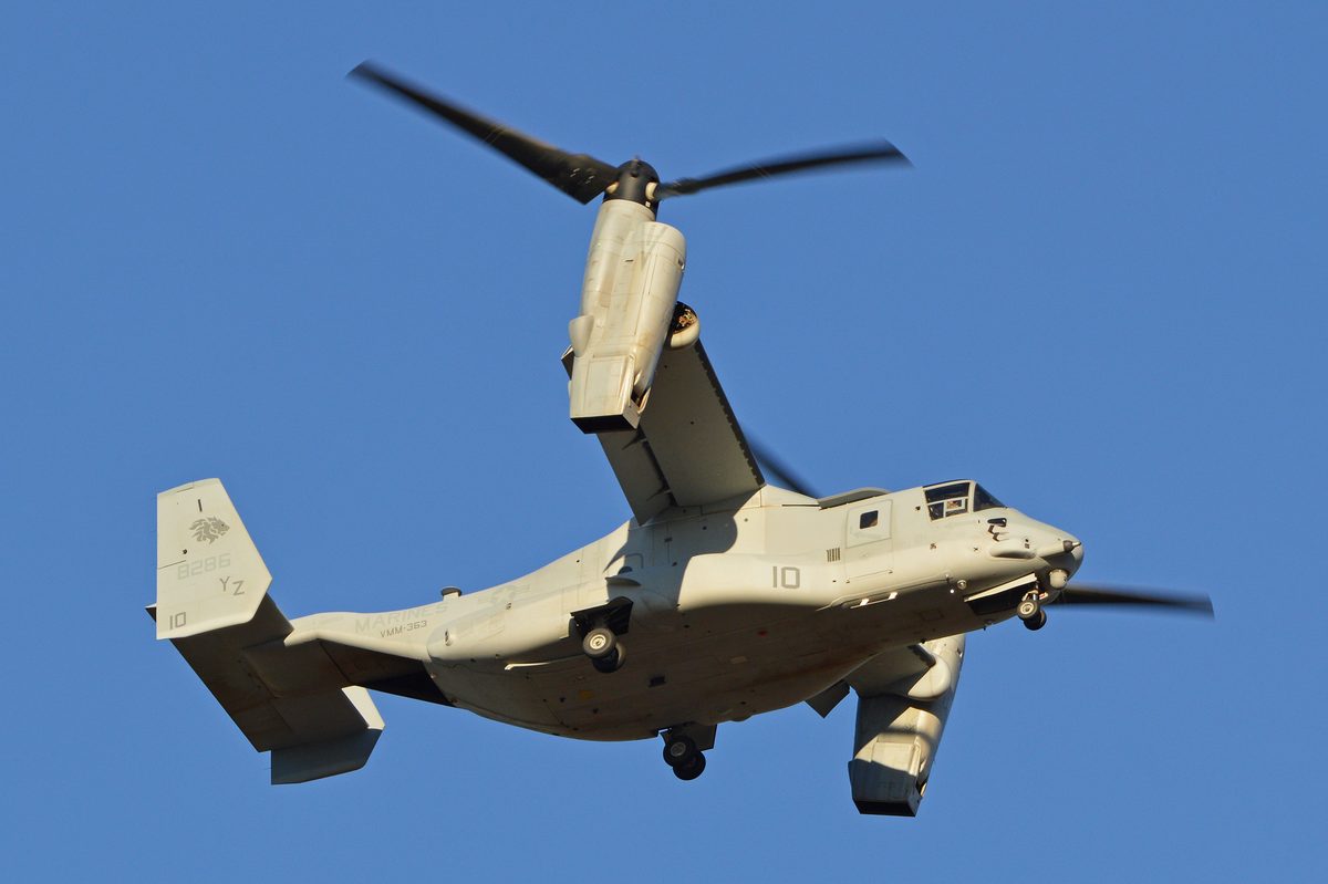 A Marine Corps MV-22 Osprey in flight against a blue sky