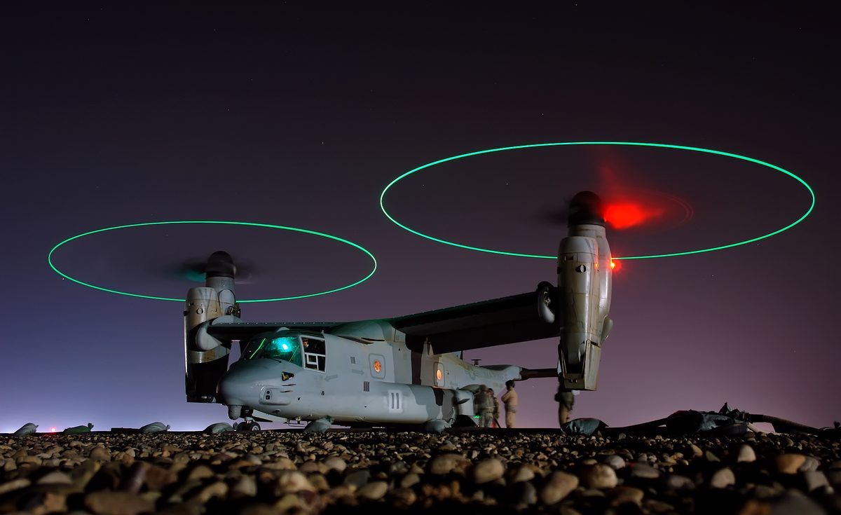 A Marine Corps MV-22 Osprey takes on fuel during night operations