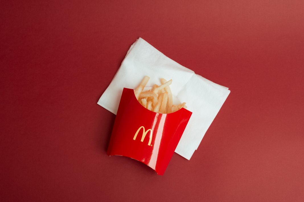 McDonald's french fries in the red carton, close up.