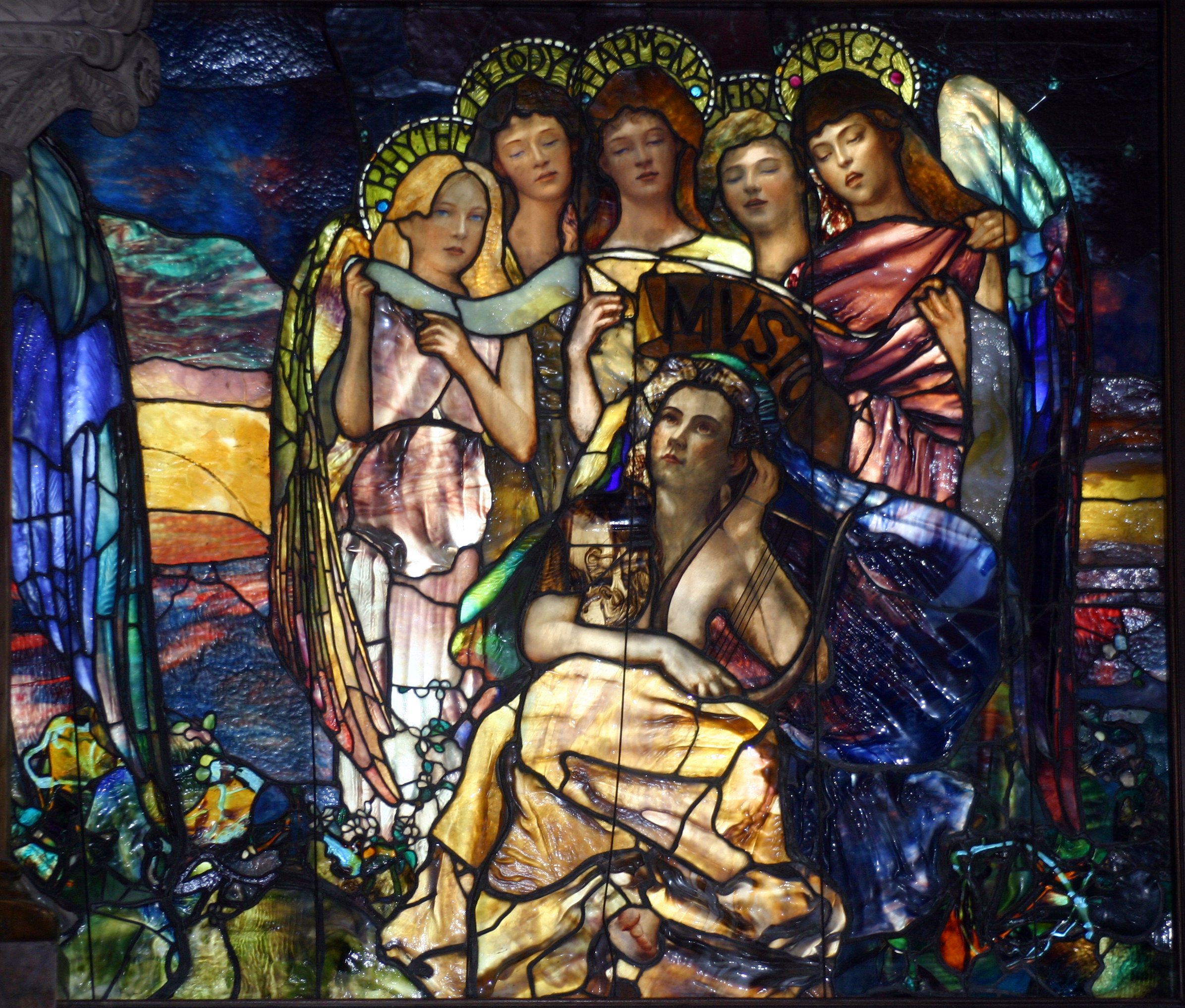 A Tiffany stained glass window with rich blue and amber glass