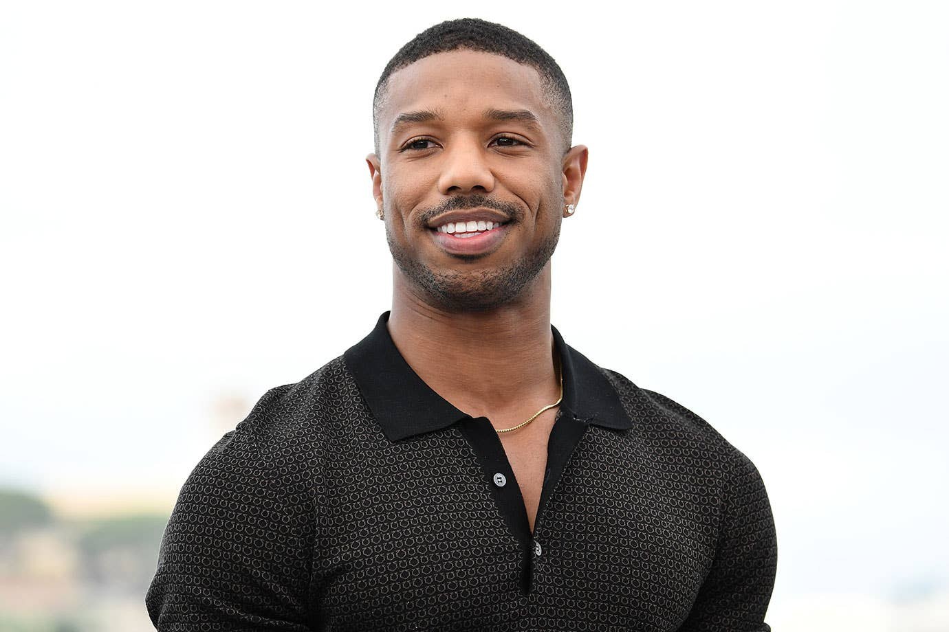 Michael B. Jordan smiling at an outdoor event
