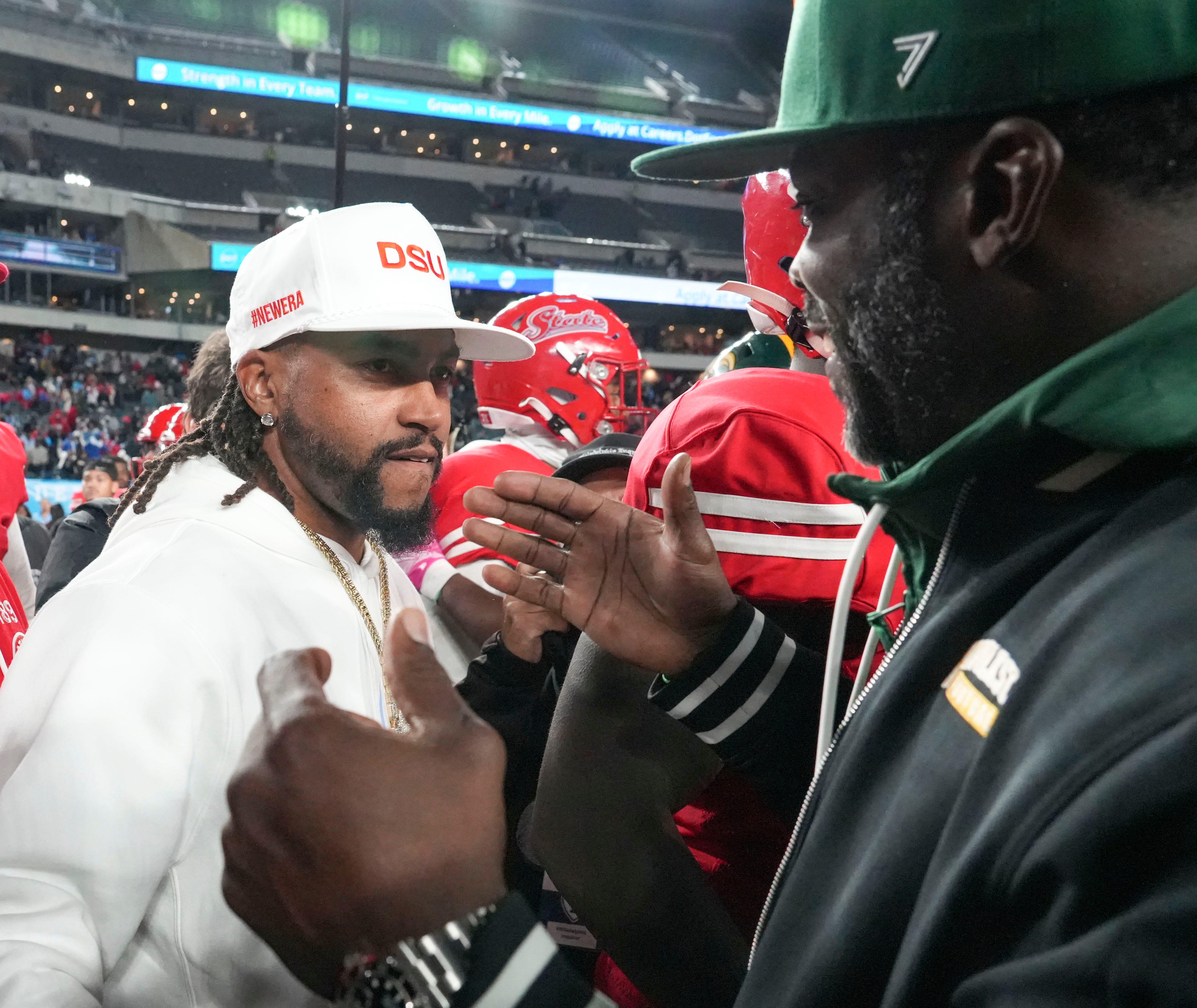 Delaware State head coach DeSean Jackson (left, white DSU cap) and Norfolk State head coach Michael Vick (right, green cap) meet at midfield at Lincoln Financial Field after Delaware State's 27–20 win on October 30, 2025